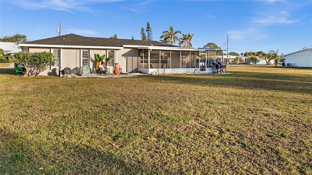 3265 Sunrise Trl, Port Charlotte, FL 33952 - back of property featuring a sunroom, a lawn, and a patio