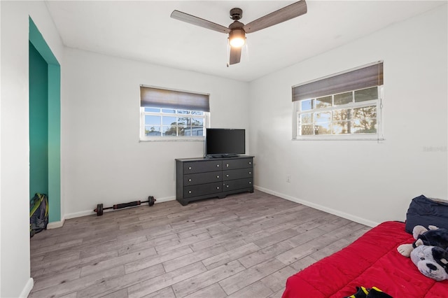 3265 Sunrise Trl, Port Charlotte, FL 33952 - unfurnished bedroom featuring multiple windows, wood finished floors, and ceiling fan