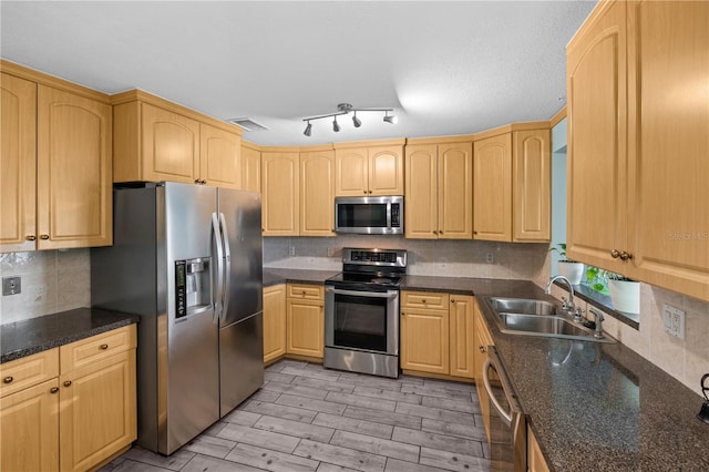 3265 Sunrise Trl, Port Charlotte, FL 33952 - kitchen featuring stainless steel appliances, light brown cabinetry, backsplash, light wood-style flooring, and dark stone countertops