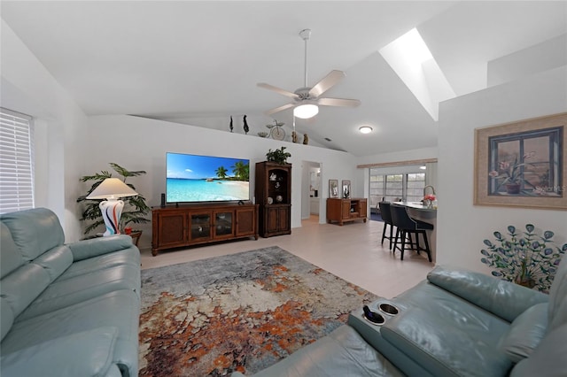 living room featuring a ceiling fan and vaulted ceiling