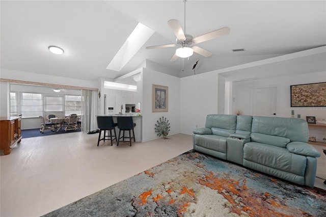 living room with lofted ceiling with skylight, visible vents, and a ceiling fan