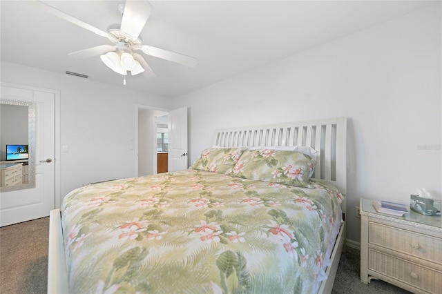 carpeted bedroom with visible vents and a ceiling fan