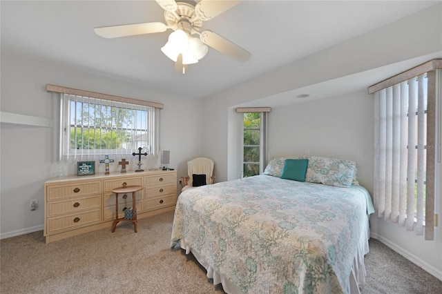 bedroom with light carpet, ceiling fan, and baseboards