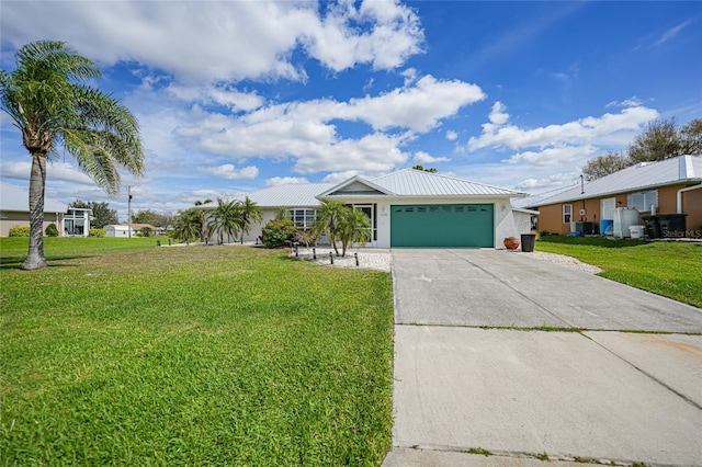 view of front of home featuring a garage, concrete driveway, metal roof, a front yard, and stucco siding