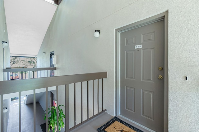 entrance to property featuring stucco siding