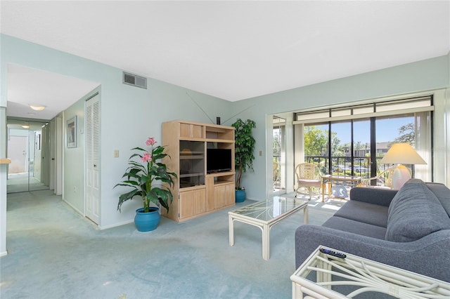 carpeted living area with visible vents and baseboards