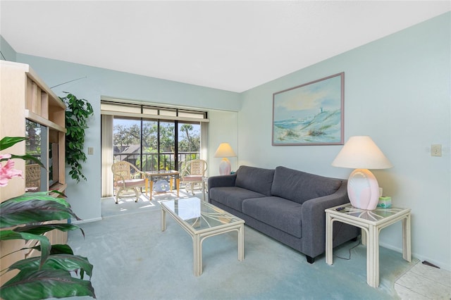 living area with light colored carpet and baseboards