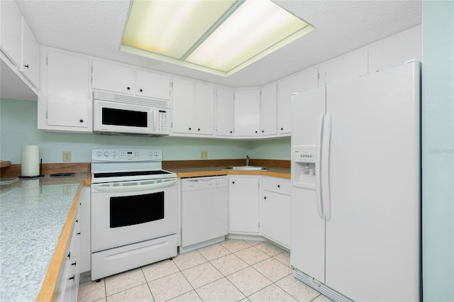 kitchen featuring light countertops, white appliances, white cabinetry, and a sink