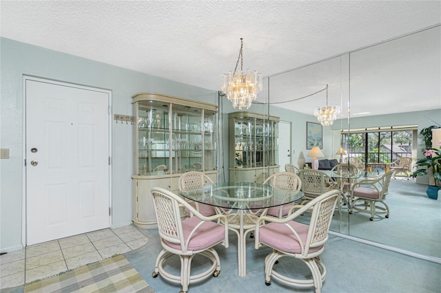 dining space with a chandelier, a textured ceiling, and light tile patterned flooring