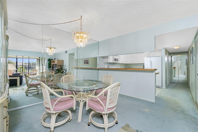 dining area with a chandelier, a textured ceiling, and light colored carpet