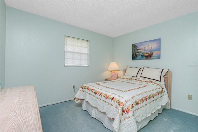 bedroom with carpet floors, baseboards, and a textured ceiling