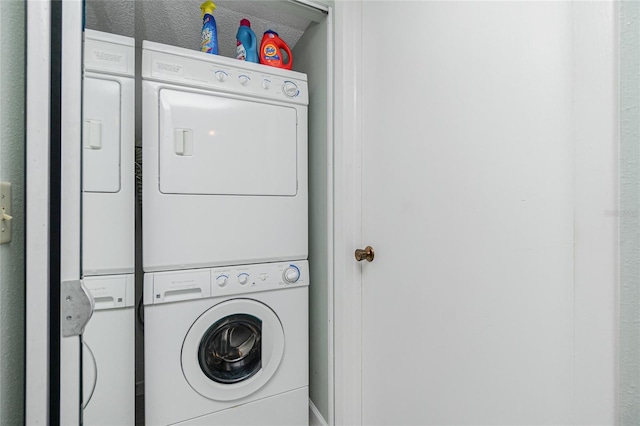 washroom featuring laundry area and stacked washing maching and dryer