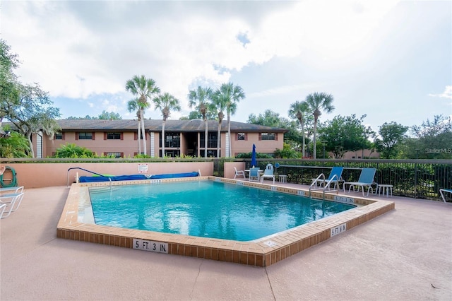 pool featuring a patio and fence