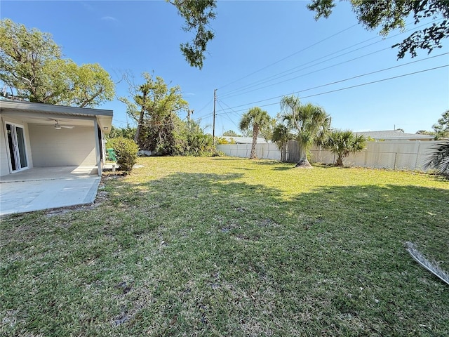 view of yard with a patio, ceiling fan, and fence