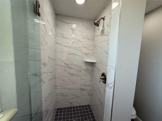 full bath with toilet and a stall shower