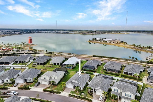 drone / aerial view featuring a water view and a residential view