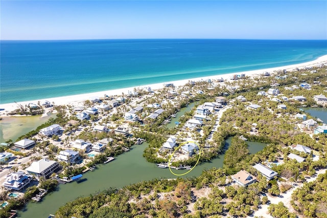 bird's eye view with a view of the beach, a water view, and a residential view