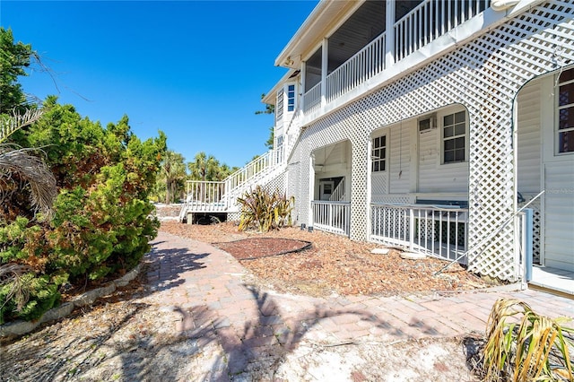 20 Palm Dr, Placida, FL 33946 - view of side of home featuring stairway