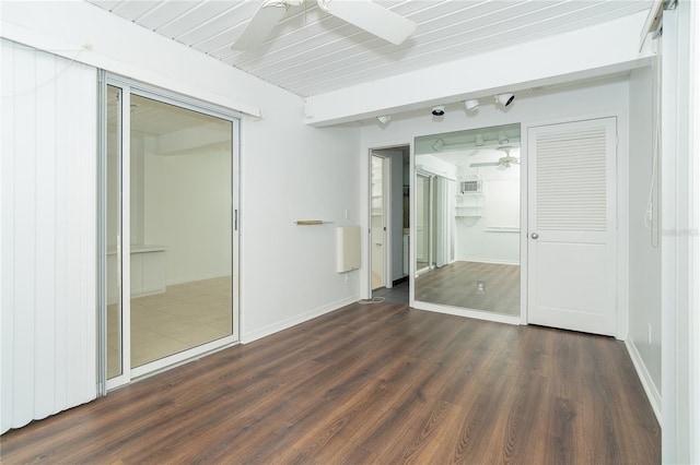 20 Palm Dr, Placida, FL 33946 - unfurnished bedroom with wood finished floors, baseboards, a wall mounted AC, and beam ceiling