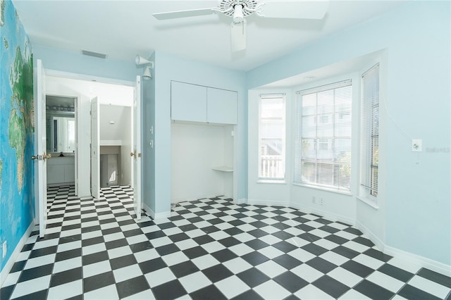 20 Palm Dr, Placida, FL 33946 - unfurnished bedroom with tile patterned floors, a closet, a ceiling fan, and baseboards