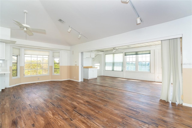 20 Palm Dr, Placida, FL 33946 - unfurnished living room with a ceiling fan, track lighting, lofted ceiling, wood finished floors, and baseboards