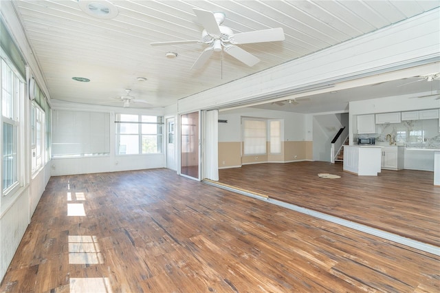 20 Palm Dr, Placida, FL 33946 - unfurnished living room with a ceiling fan, hardwood / wood-style flooring, and stairway
