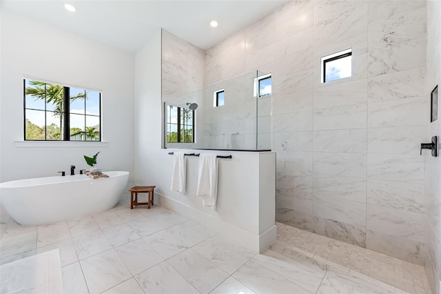 bathroom with a walk in shower, marble finish floor, a freestanding bath, and recessed lighting