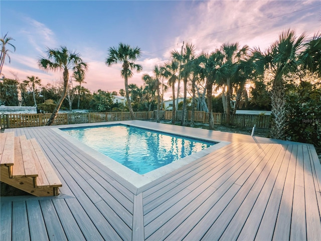 view of swimming pool with a fenced in pool, a fenced backyard, and a deck