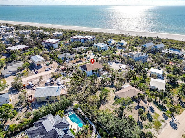 bird's eye view featuring a water view, a residential view, and a beach view