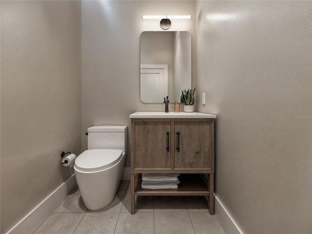 half bath featuring toilet, tile patterned flooring, vanity, and baseboards