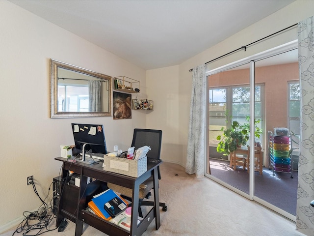 home office featuring carpet floors and a wealth of natural light