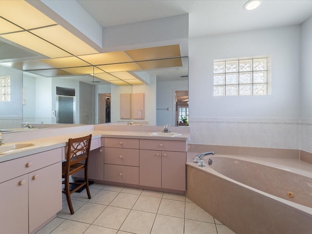 full bathroom with plenty of natural light, tile patterned flooring, and vanity