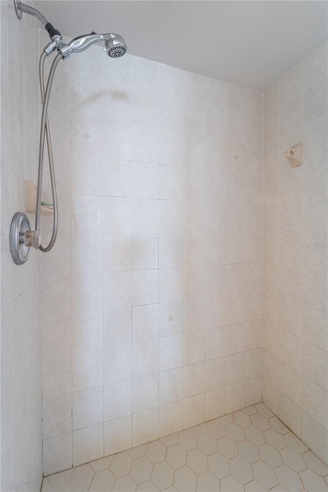 full bath with a tile shower