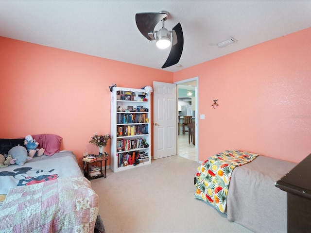 carpeted bedroom featuring ceiling fan and visible vents