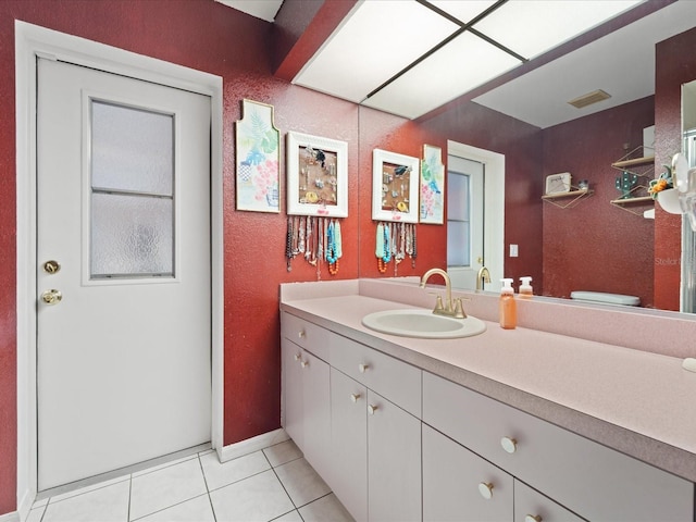 bathroom with visible vents, vanity, and tile patterned floors