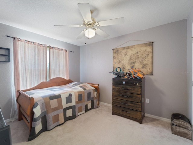 bedroom with light carpet, ceiling fan, and baseboards