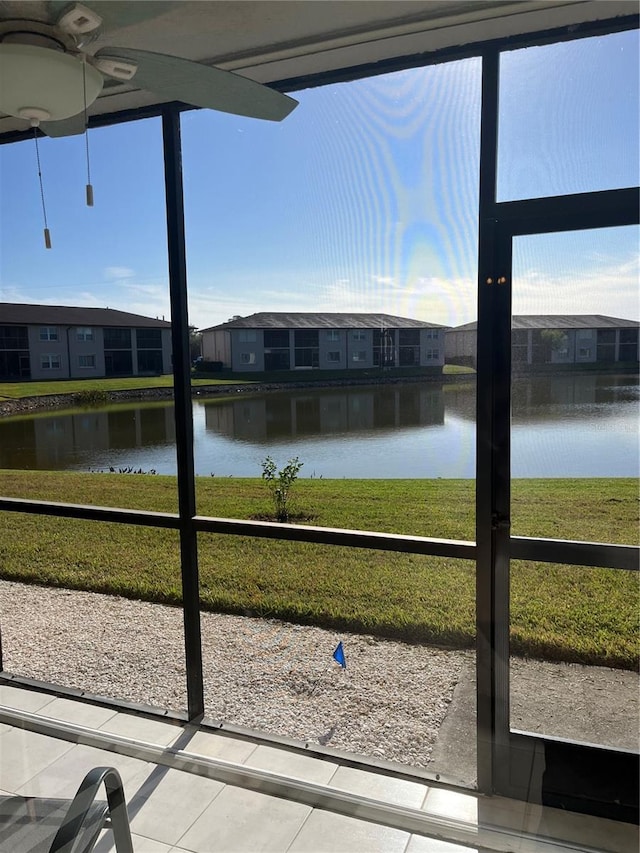 interior space featuring a residential view, a water view, and plenty of natural light