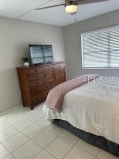 bedroom with a ceiling fan and light tile patterned flooring