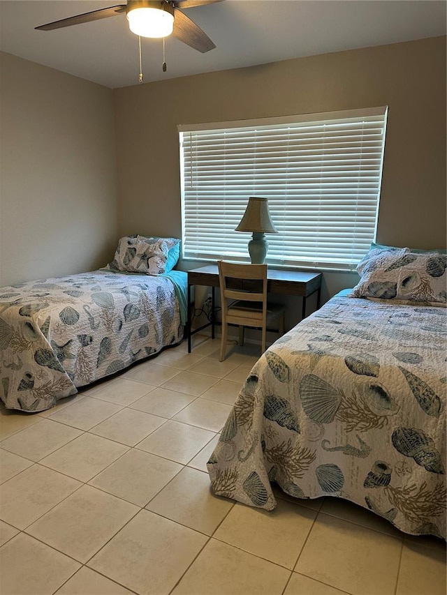 bedroom with ceiling fan and light tile patterned floors