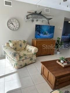 living area featuring light tile patterned floors and visible vents