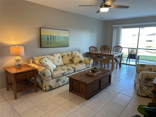 living area featuring light tile patterned floors and a ceiling fan