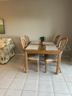 dining area featuring baseboards and tile patterned floors