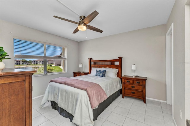 25100 Sandhill Blvd Unit R104, Punta Gorda, FL 33983 - bedroom with baseboards, light tile patterned floors, and a ceiling fan