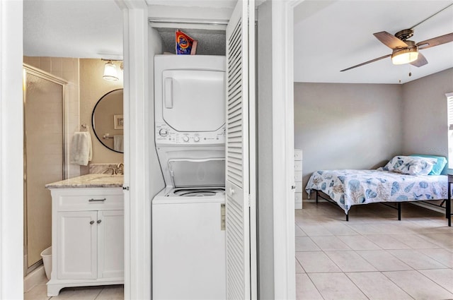 25100 Sandhill Blvd Unit R104, Punta Gorda, FL 33983 - clothes washing area featuring stacked washer / drying machine, ceiling fan, and light tile patterned floors