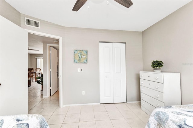 25100 Sandhill Blvd Unit R104, Punta Gorda, FL 33983 - bedroom featuring light tile patterned floors, a closet, baseboards, and ceiling fan