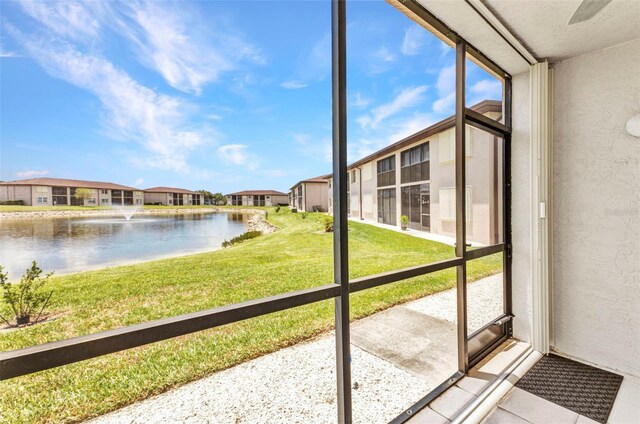 25100 Sandhill Blvd Unit R104, Punta Gorda, FL 33983 - unfurnished sunroom featuring a water view, healthy amount of natural light, and a residential view