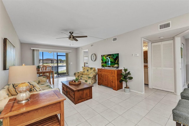 25100 Sandhill Blvd Unit R104, Punta Gorda, FL 33983 - living area featuring a ceiling fan, light tile patterned floors, and baseboards
