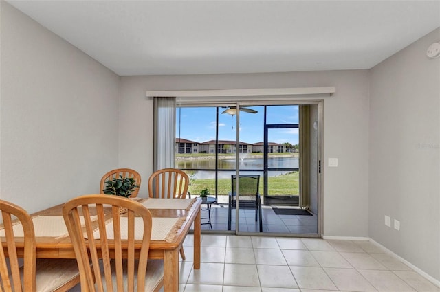 25100 Sandhill Blvd Unit R104, Punta Gorda, FL 33983 - dining room featuring a water view, light tile patterned floors, and baseboards