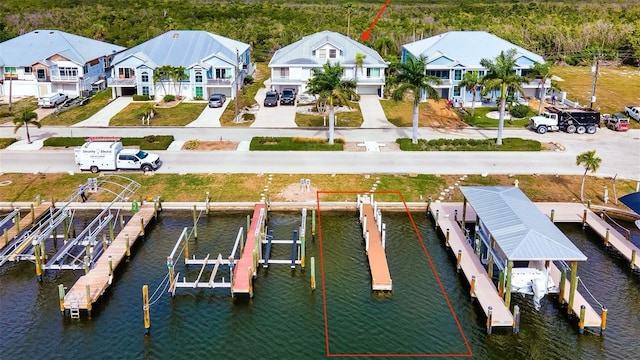 birds eye view of property featuring a water view and a residential view