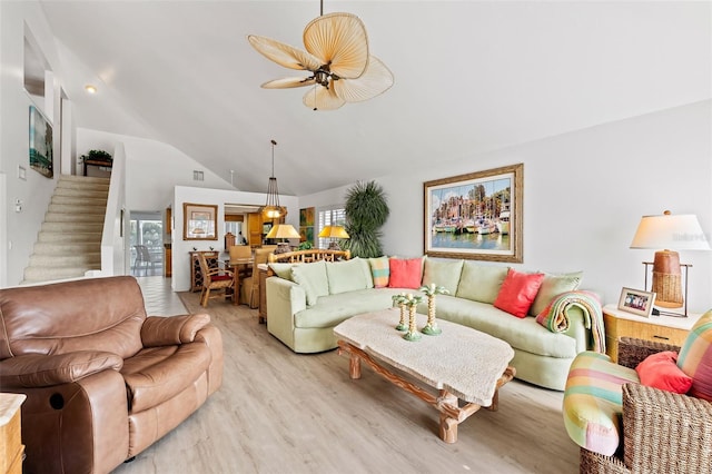 12130 Siesta Dr, Fort Myers Beach, FL 33931 - living area with lofted ceiling, light wood-style floors, stairway, and a ceiling fan